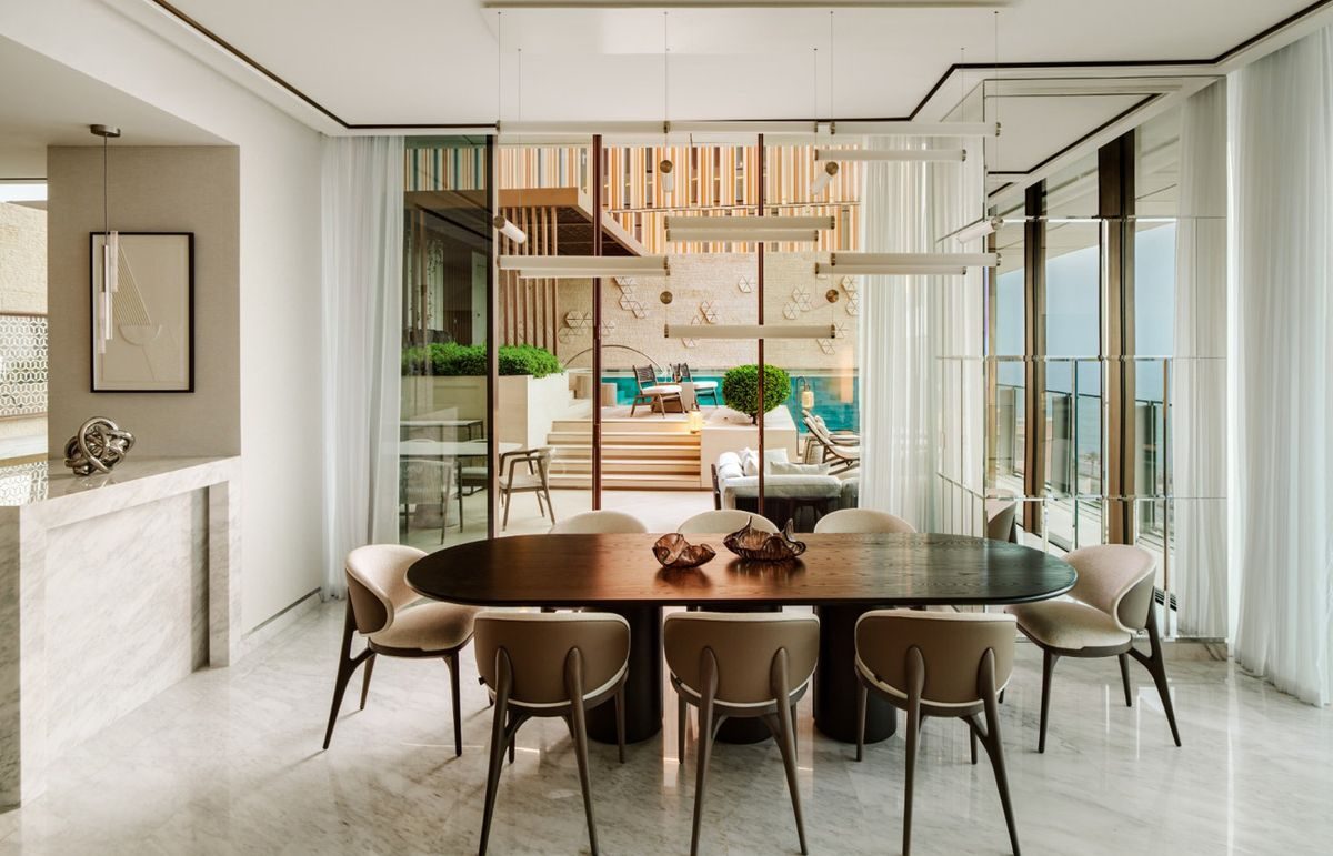 Visualisation of the dining room of Jumeirah Villa 03, warm timber and low light